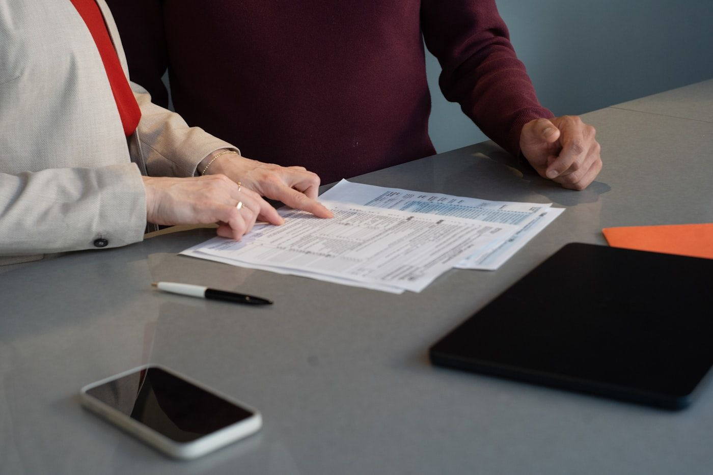 Hands reviewing paperwork at a table